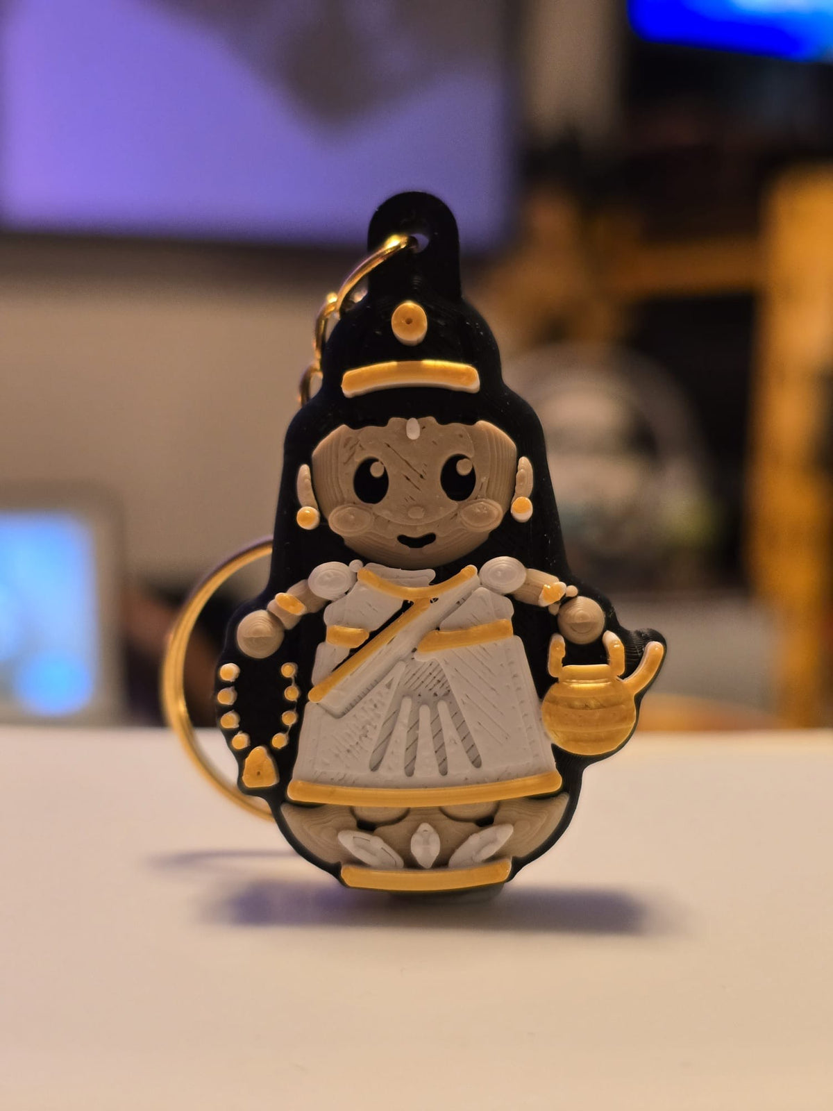 Brahmacharini keychain: chibi devi in a white sari holding prayer beads and a gold water pot, standing on a lotus
